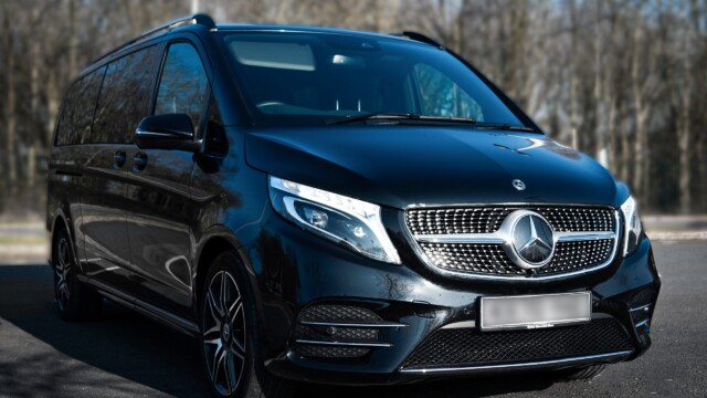 Wide angle shot of a Black Mercedes V-class from the front and side
